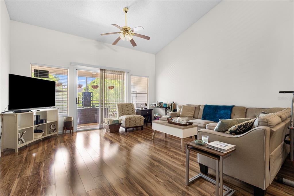 6029 Lake Pointe Drive, Unit 202 Orlando, FL 32822 - Photo 6 of 28 a living room with furniture and a flat screen tv