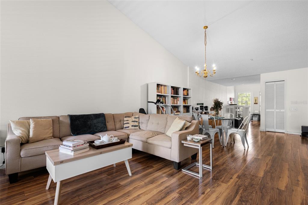 6029 Lake Pointe Drive, Unit 202 Orlando, FL 32822 - Photo 7 of 28 a living room with furniture and a wooden floor