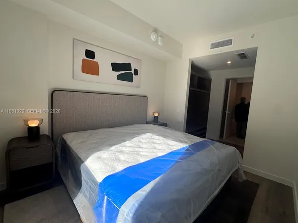 a bedroom with a bed and a mirror