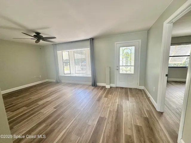 wooden floor in an empty room with a window