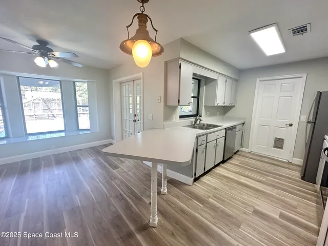 a spacious bathroom with a granite countertop sink window and a mirror
