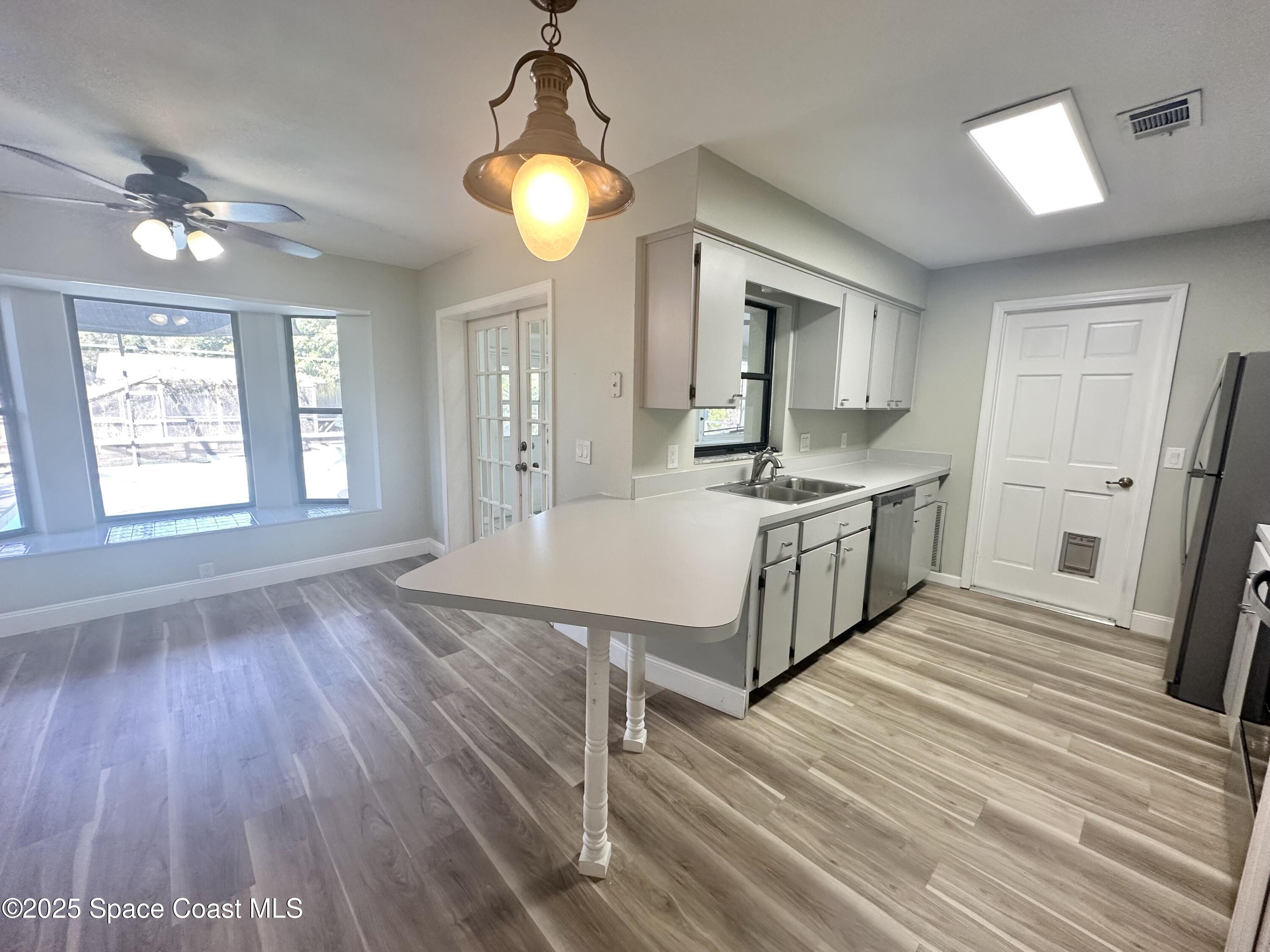 4140 Delespine Road Cocoa, FL 32927 - Photo 5 of 12 a spacious bathroom with a granite countertop sink window and a mirror