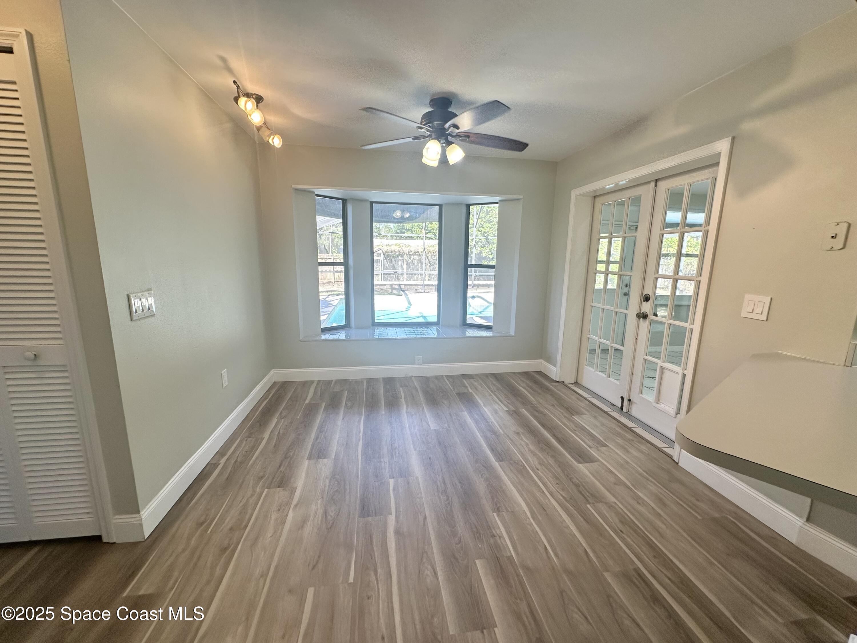 4140 Delespine Road Cocoa, FL 32927 - Photo 6 of 12 wooden floor in an empty room with a window