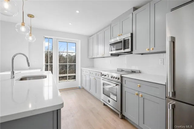 a kitchen with a sink stove and cabinets