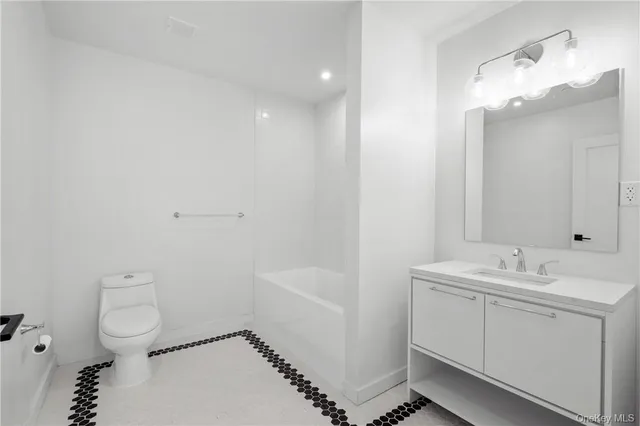 a bathroom with a toilet sink and shower