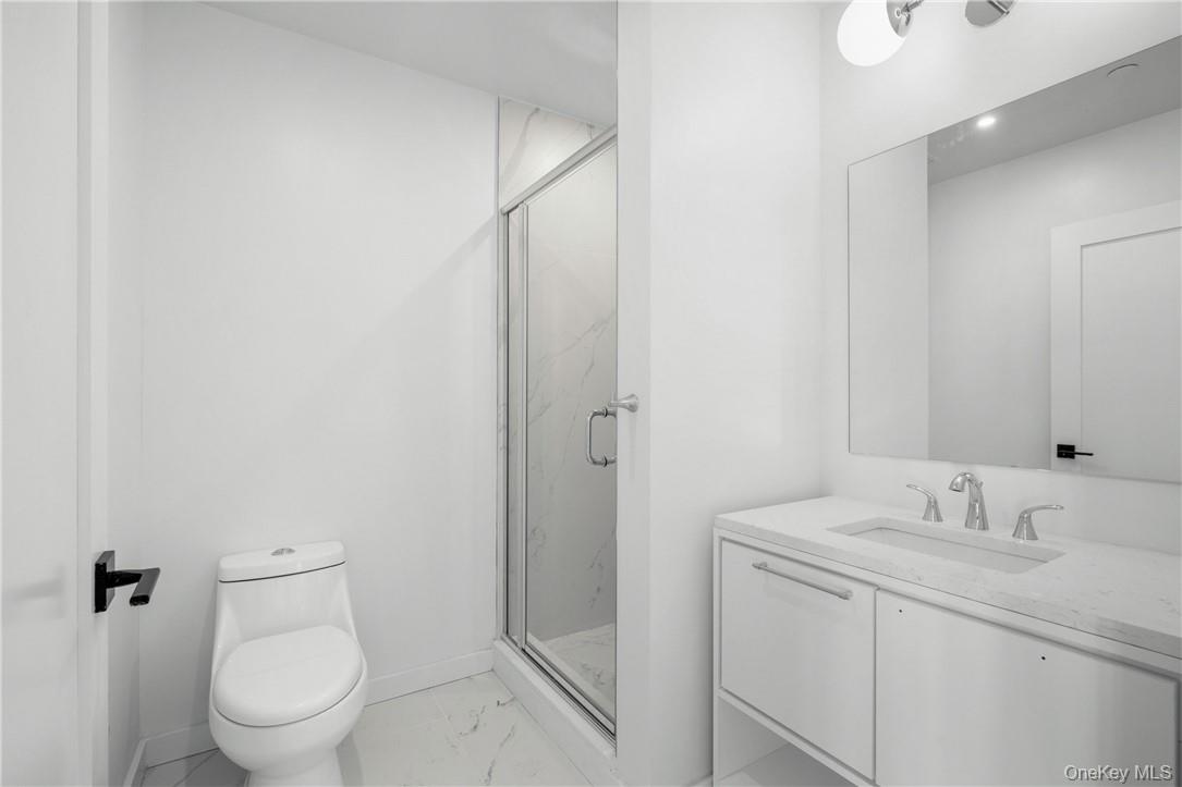 139 Fifth Avenue, Unit 5C Pelham, NY 10803 - Photo 17 of 32 a bathroom with a toilet sink and shower