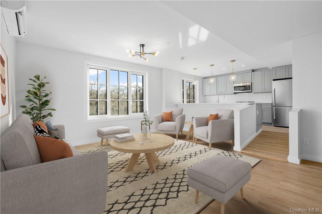 139 Fifth Avenue, Unit 5C Pelham, NY 10803 - Photo 2 of 32 a living room with furniture a dining table and chairs
