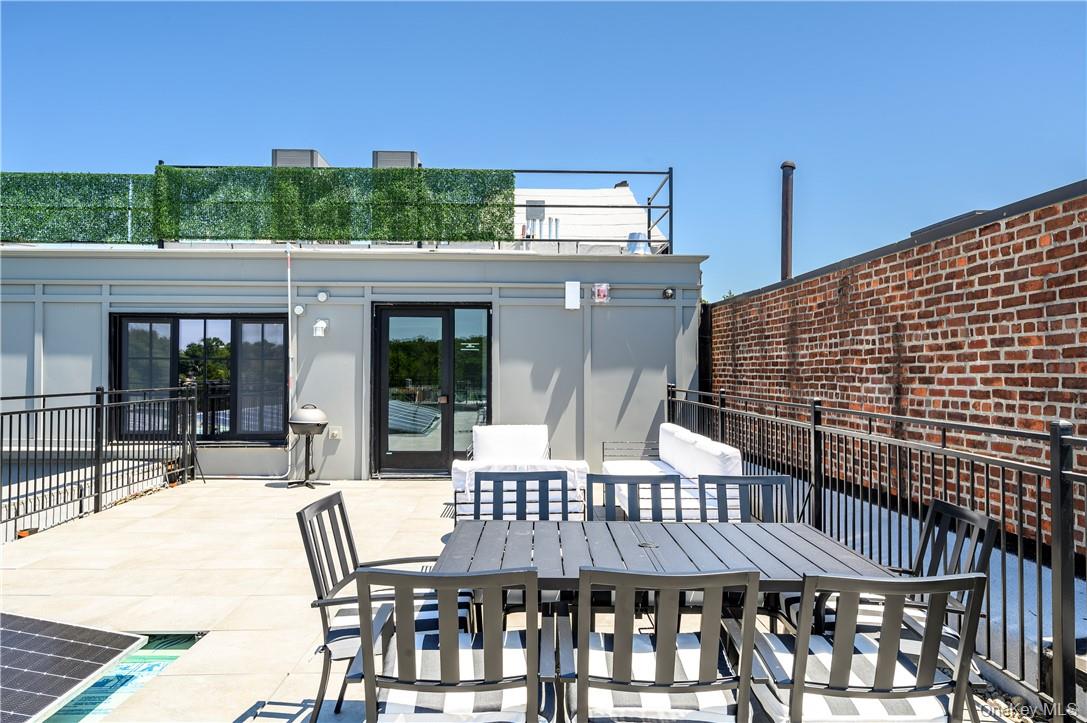 139 Fifth Avenue, Unit 5C Pelham, NY 10803 - Photo 22 of 32 a view of a patio with a table and chairs
