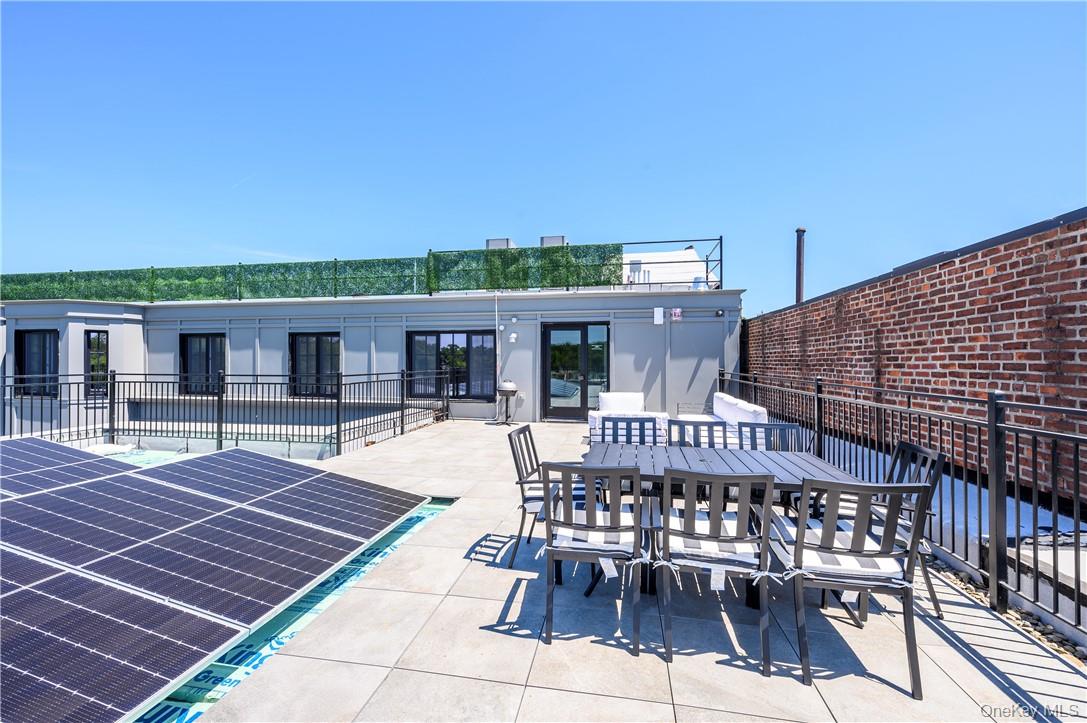 139 Fifth Avenue, Unit 5C Pelham, NY 10803 - Photo 24 of 32 a patio with glass top table and chairs