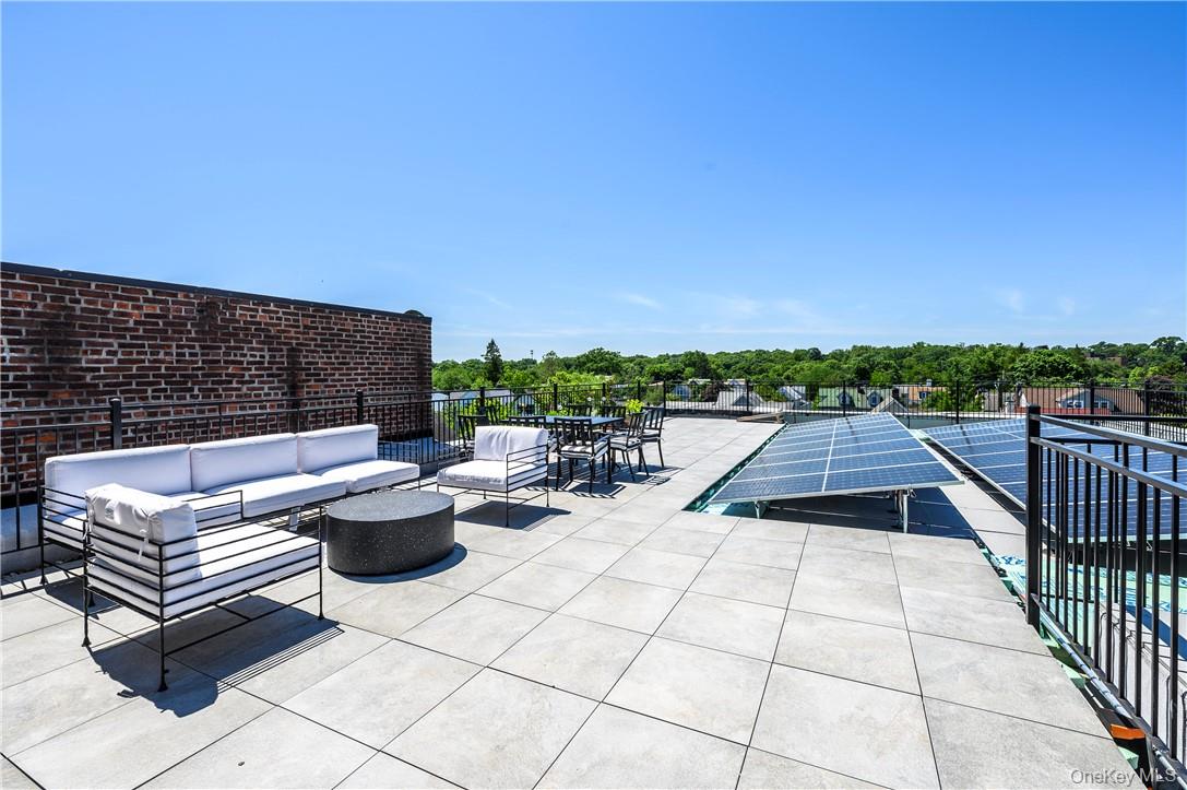 139 Fifth Avenue, Unit 5C Pelham, NY 10803 - Photo 25 of 32 a view of a terrace with couches and lounge chairs