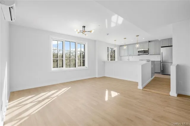 a view of a kitchen with wooden floor and windows