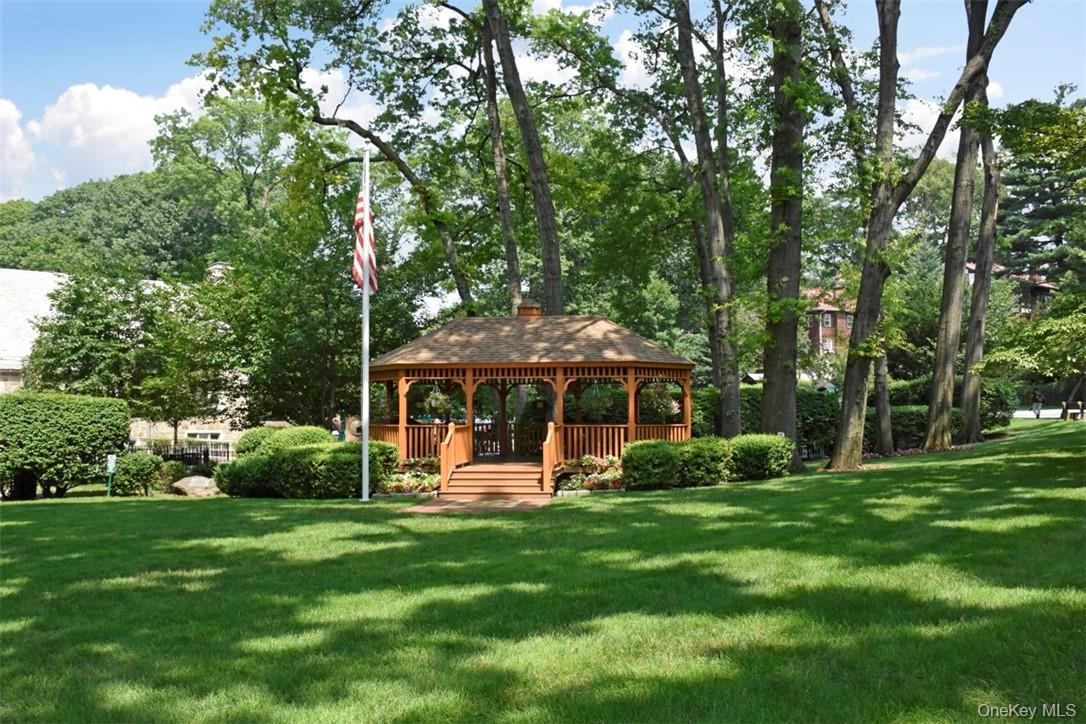 139 Fifth Avenue, Unit 5C Pelham, NY 10803 - Photo 30 of 32 a view of a house with a yard and tree s