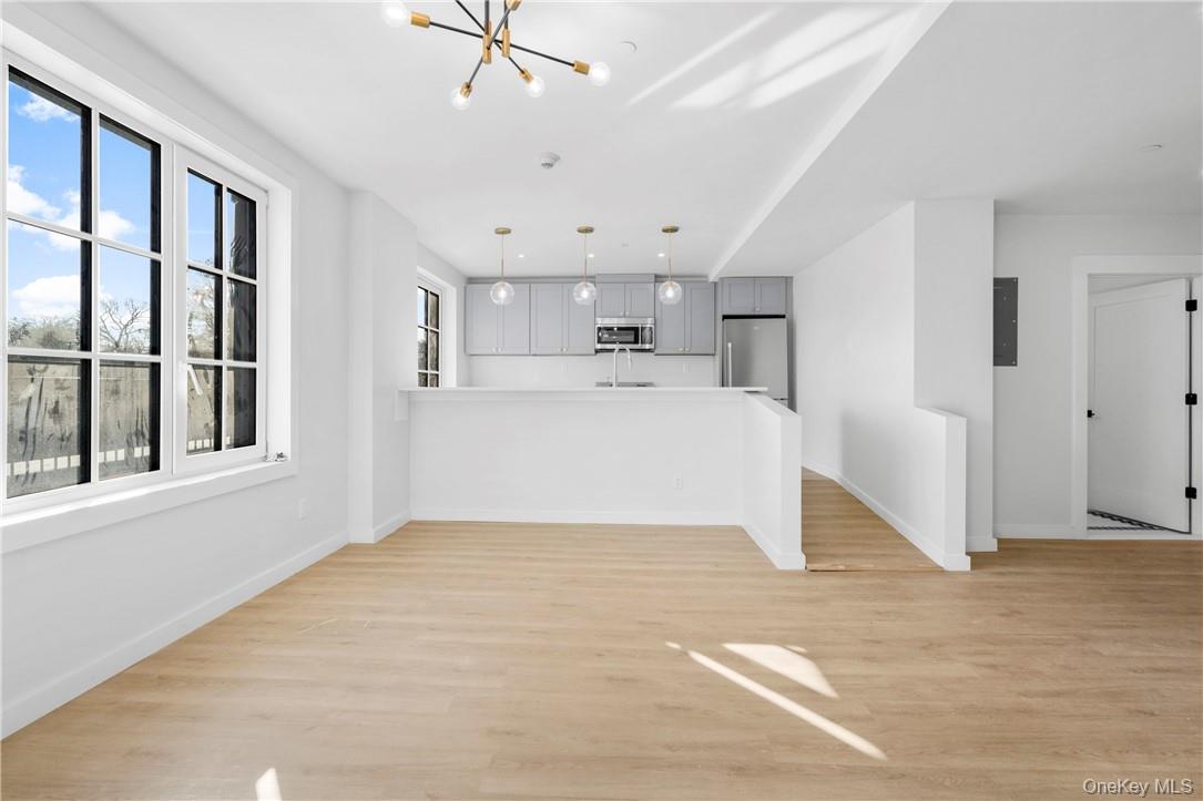 139 Fifth Avenue, Unit 5C Pelham, NY 10803 - Photo 6 of 32 a view of a kitchen with wooden cabinet and a window