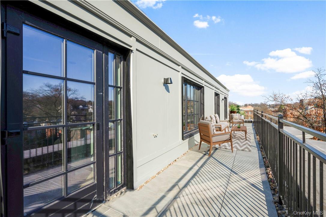 139 Fifth Avenue, Unit 5C Pelham, NY 10803 - Photo 10 of 32 a balcony with wooden floor and outdoor seating