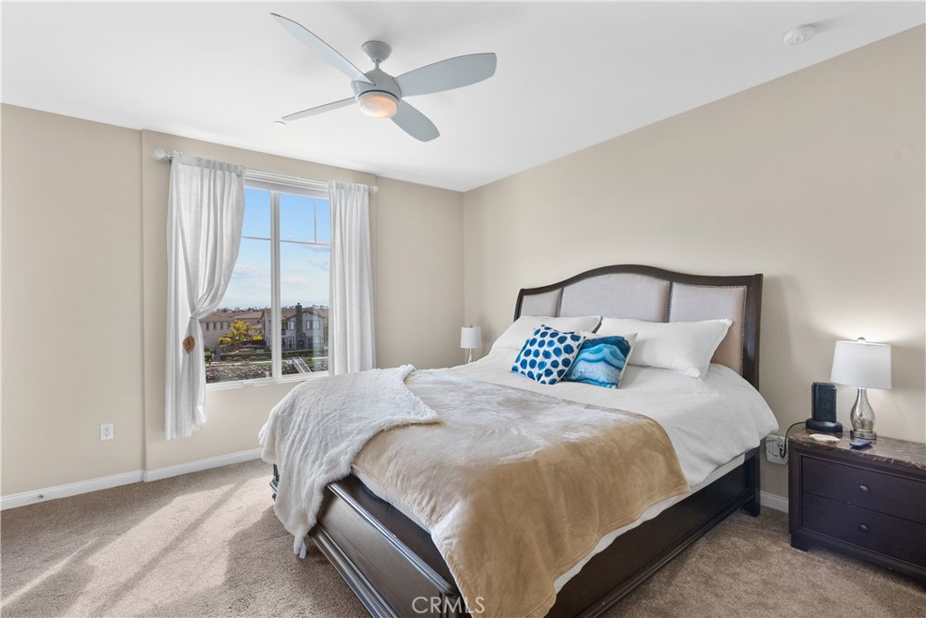 4240 Tradewinds Drive Oxnard, CA 93035 - Photo 28 of 43 a bedroom with a large bed and a large window