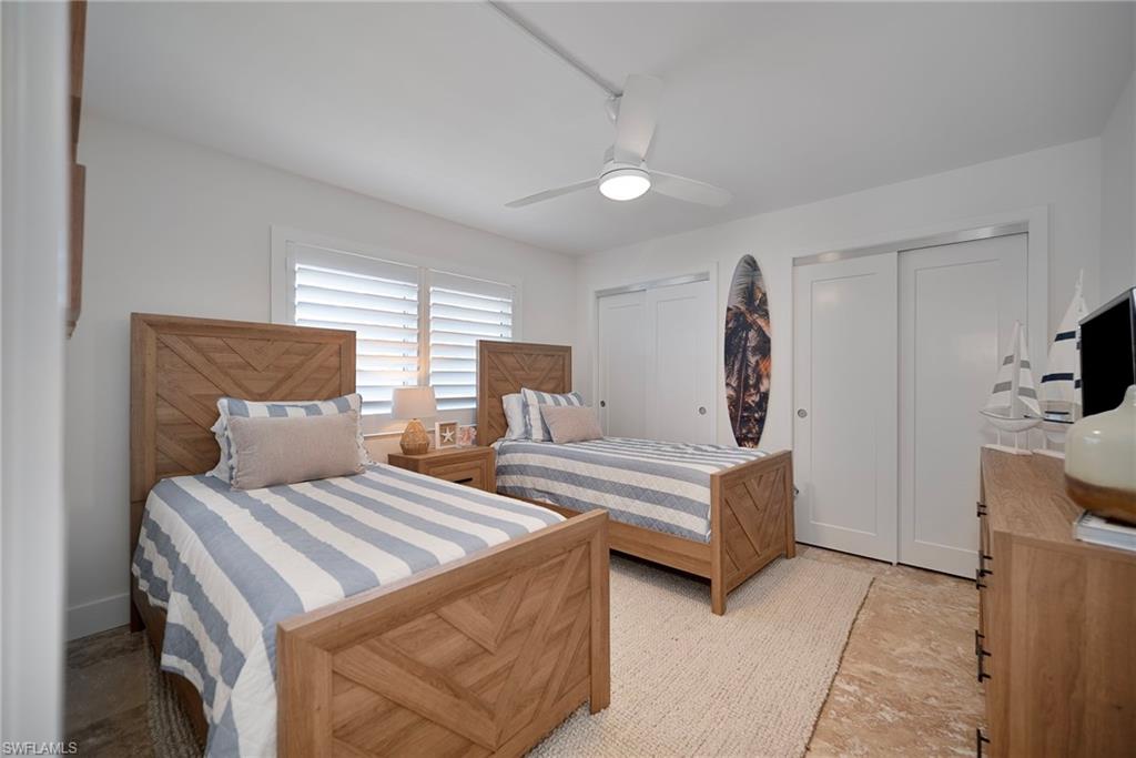 1950 Gulf Shore Boulevard North, Unit 108 Naples, FL 34102 - Photo 11 of 19 a living room with furniture and a flat screen tv