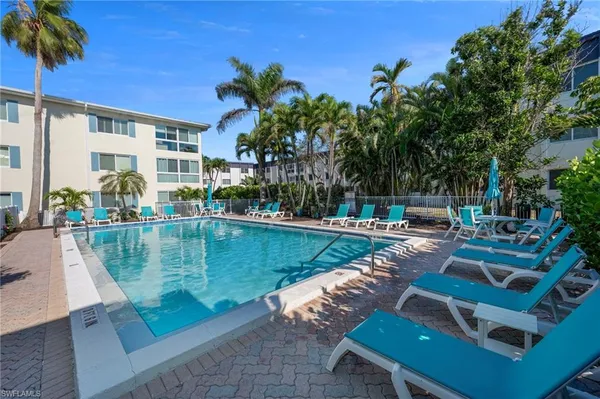 a view of swimming pool with outdoor seating and plants