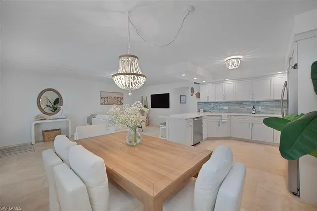 a kitchen with a table chairs and a refrigerator