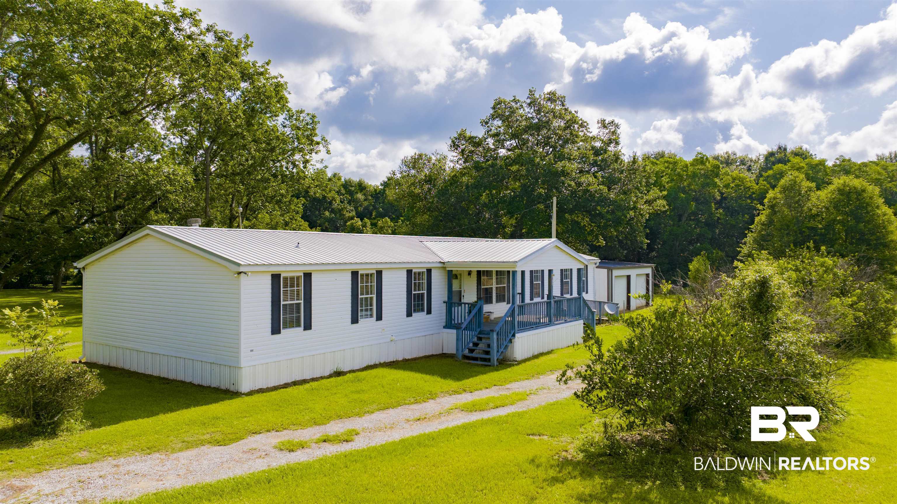 25700 County Road 71 Robertsdale, AL 36567 - Photo 34 of 40 Manufactured / mobile home with covered porch, a front lawn, a metal roof, and driveway