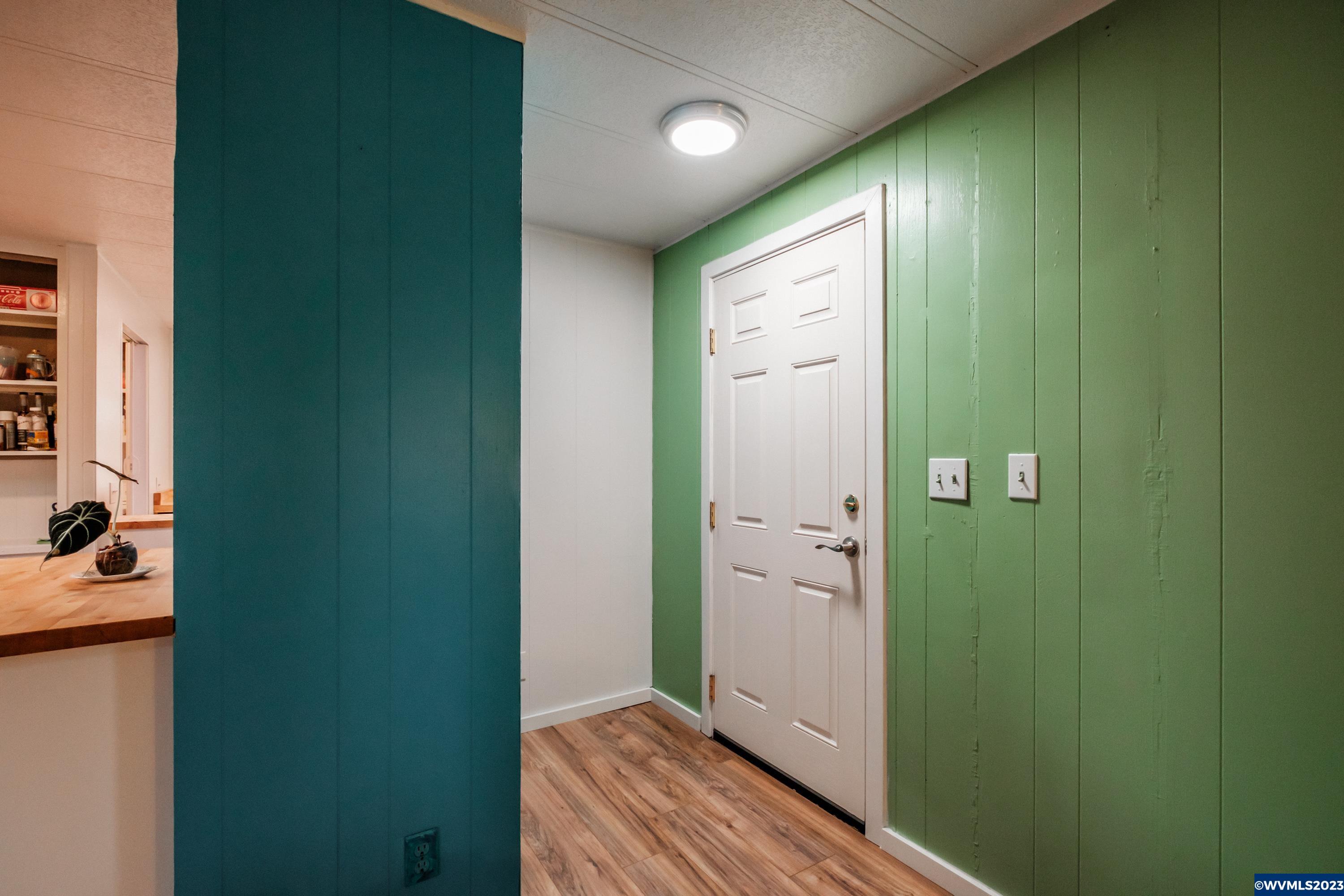 4915 Swegle Road Northeast, Unit 47 Salem, OR 97301 - Photo 13 of 36 a view of a hallway with wooden floor and a bathroom