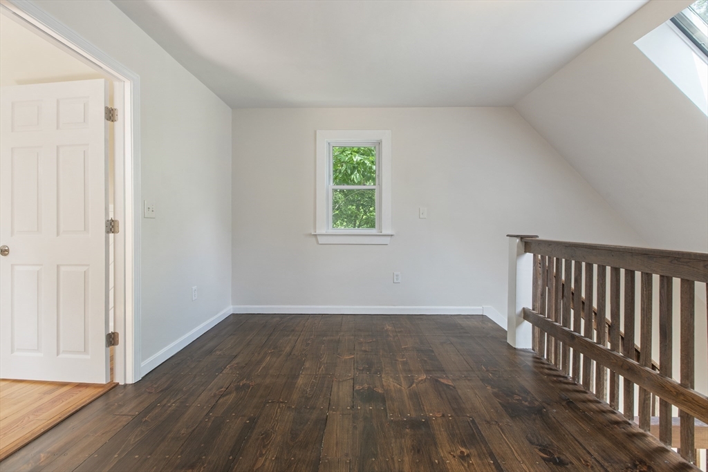68 Birch Hill Road Douglas, MA 01516 - Photo 22 of 40 an empty room with wooden floor and windows