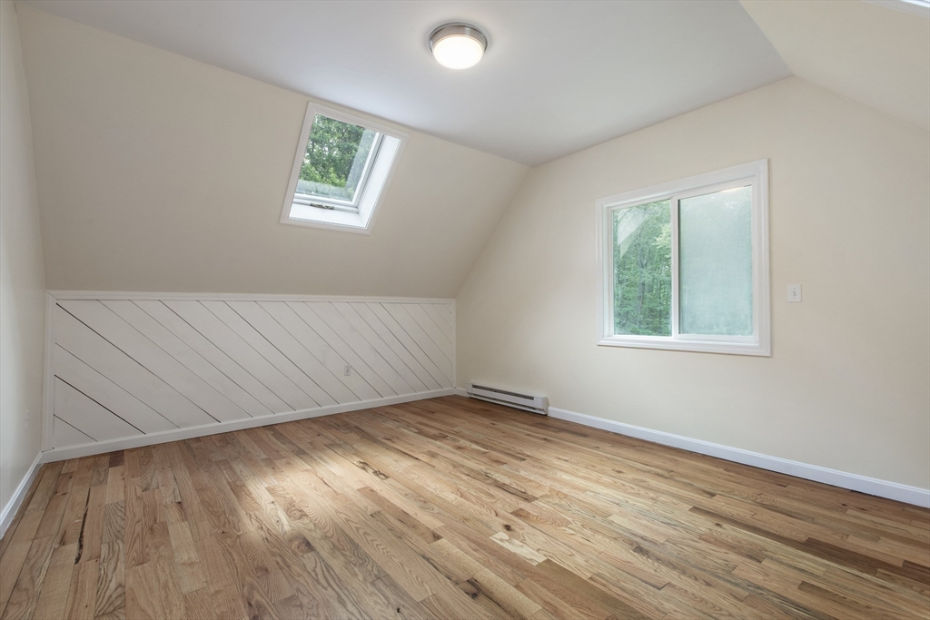 68 Birch Hill Road Douglas, MA 01516 - Photo 26 of 40 an empty room with wooden floor and windows