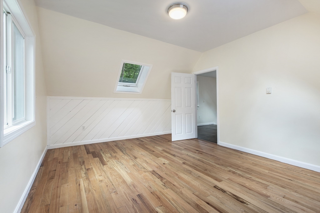 68 Birch Hill Road Douglas, MA 01516 - Photo 27 of 40 an empty room with wooden floor and windows
