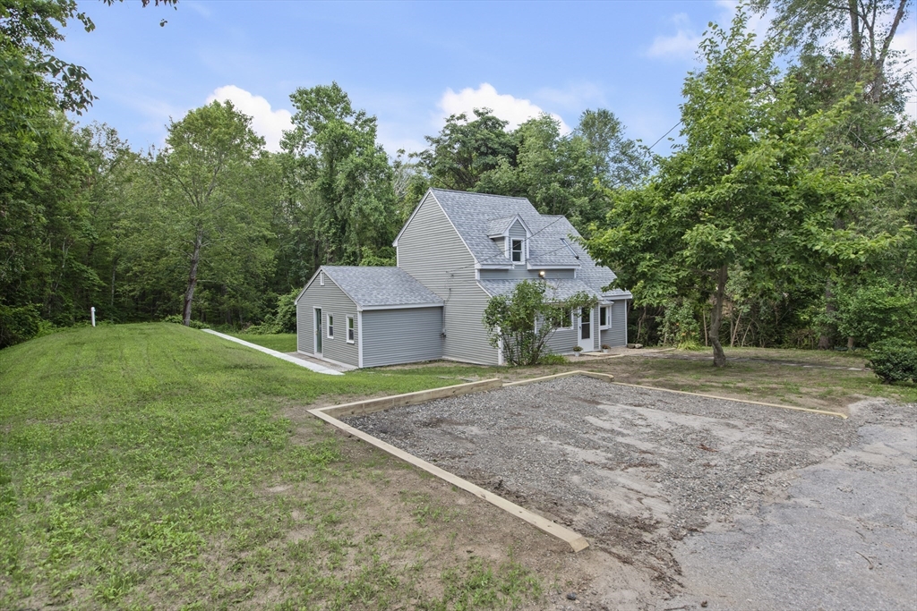 68 Birch Hill Road Douglas, MA 01516 - Photo 31 of 40 a house with green field in front of it