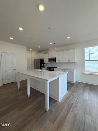 a stove top oven sitting inside of a kitchen