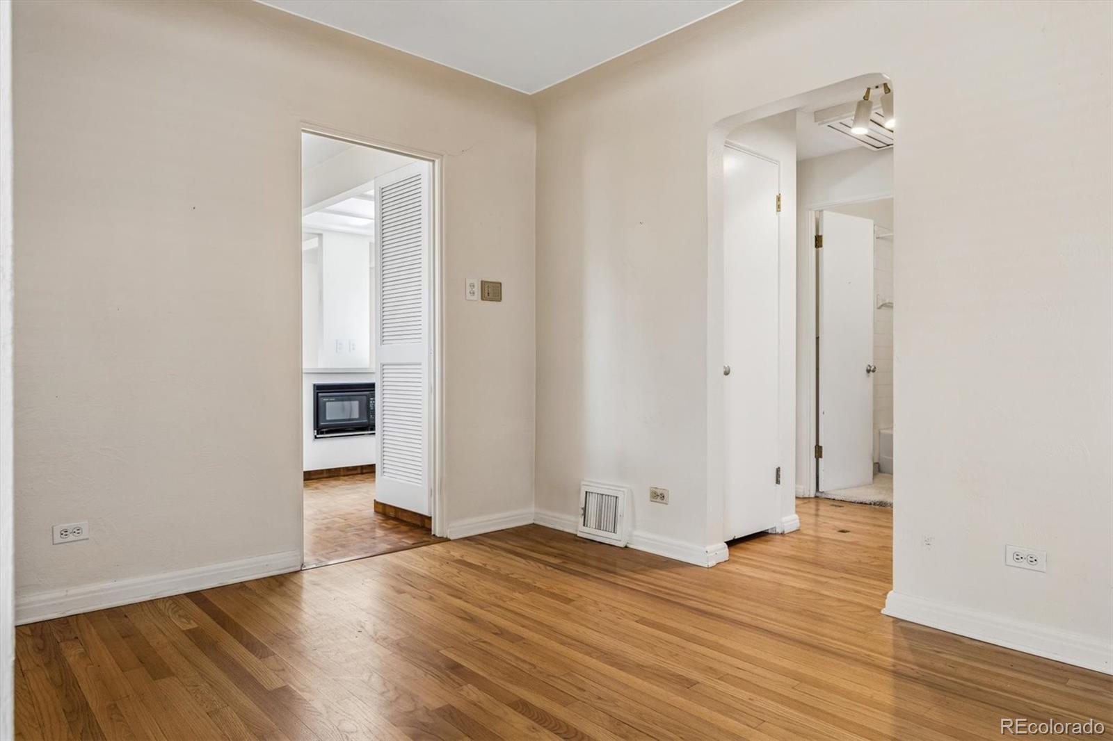 815 Oneida Street Denver, CO 80220 - Photo 14 of 39 an empty room with wooden floor and entrance