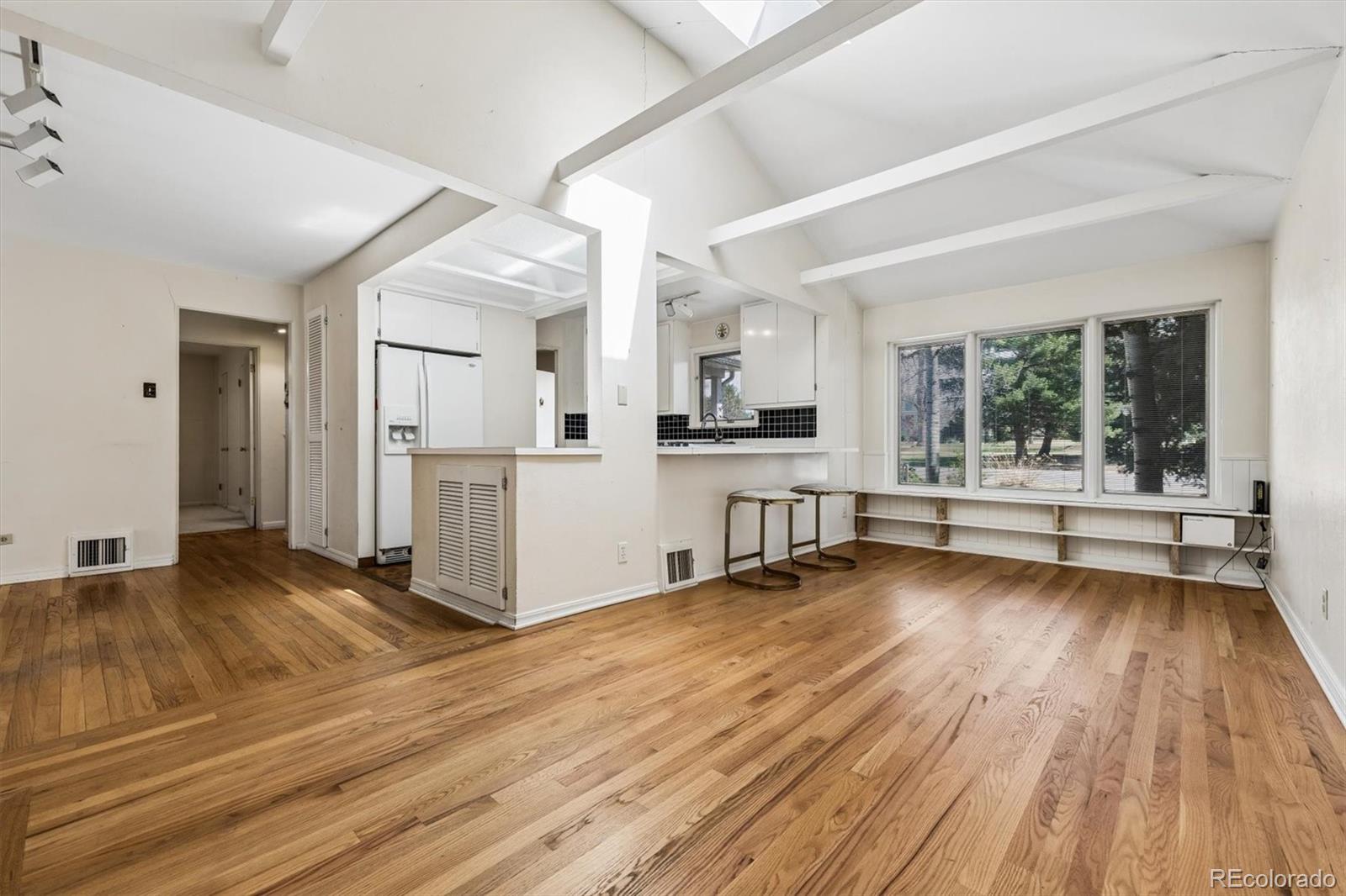 815 Oneida Street Denver, CO 80220 - Photo 17 of 39 a view of a living room with hardwood floor and a large window