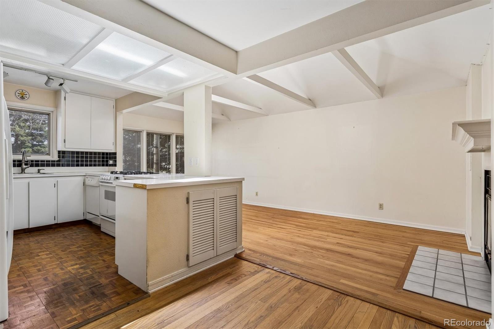 815 Oneida Street Denver, CO 80220 - Photo 19 of 39 a view of kitchen with cabinets and wooden floor
