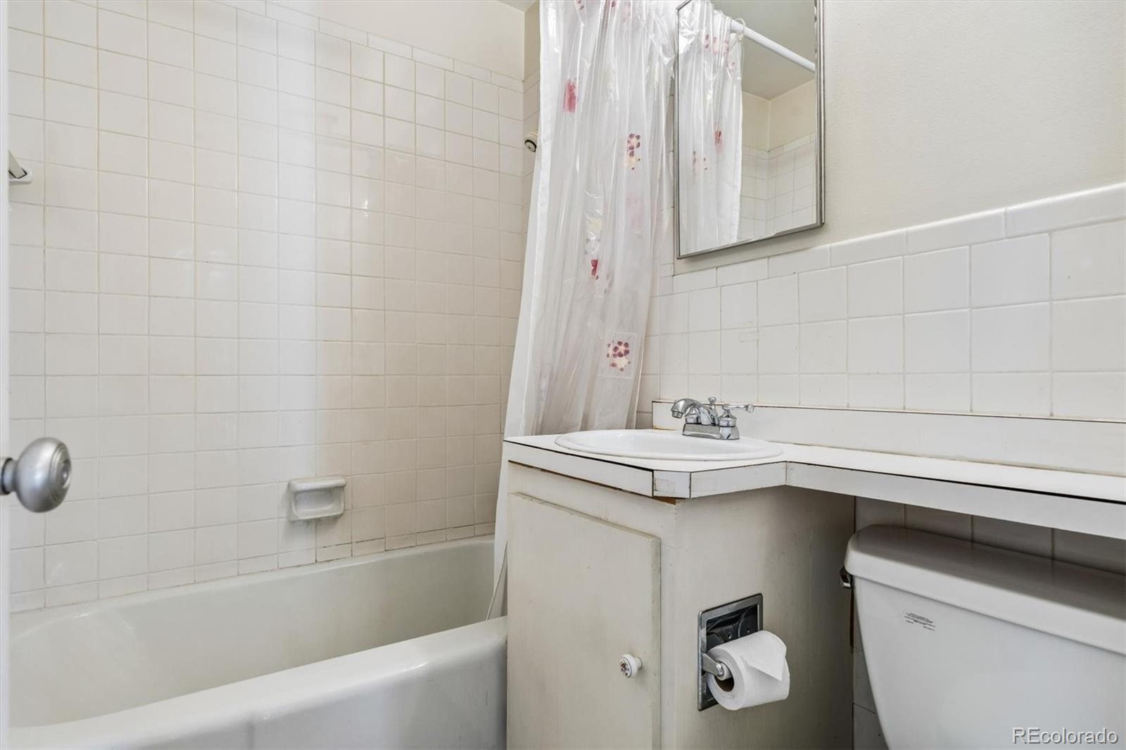 815 Oneida Street Denver, CO 80220 - Photo 27 of 39 a bathroom with a sink a toilet and bathtub