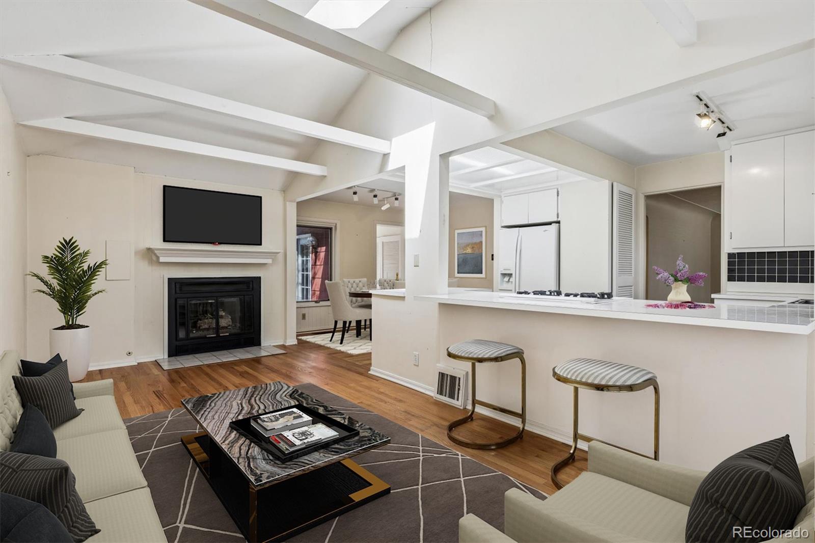 815 Oneida Street Denver, CO 80220 - Photo 7 of 39 a living room with furniture and a fireplace