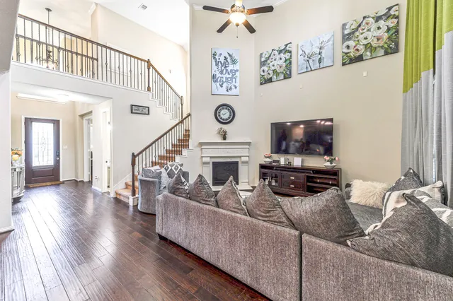 a living room with furniture a flat screen tv and a fireplace
