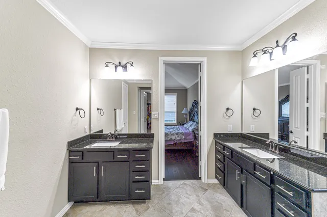a spacious bathroom with a granite countertop sink and a mirror