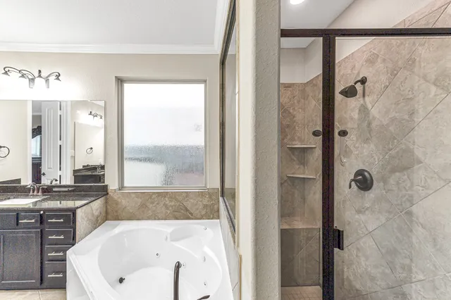a bathroom with a tub and a shower