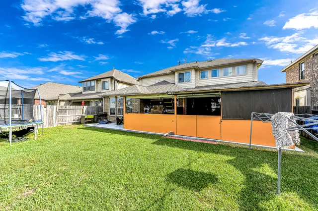 a view of house with swimming pool yard and outdoor seating