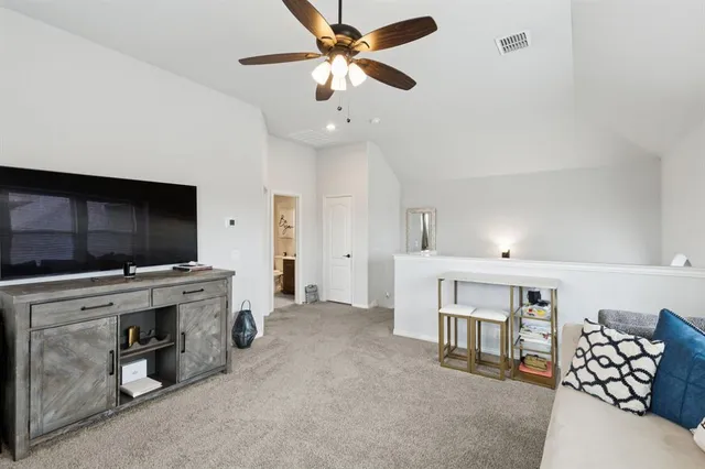 a view of a livingroom with furniture and a flat screen tv