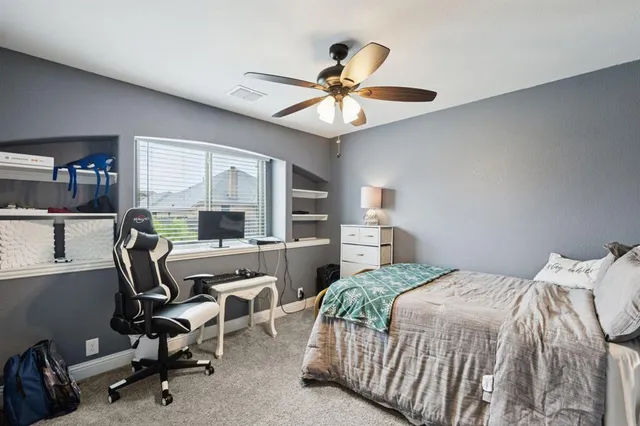 a bedroom with a bed a desk and chair