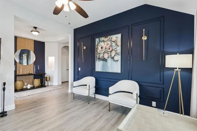 a workspace with furniture wooden floor and window