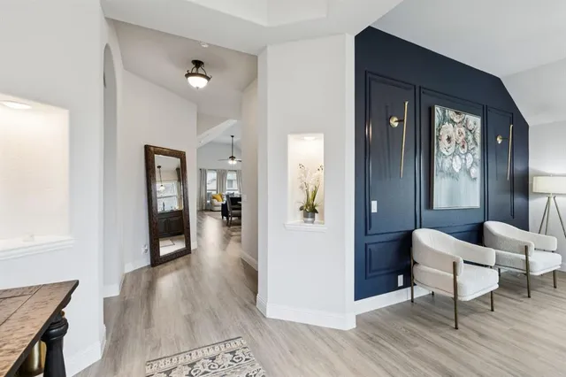 a living room with furniture and a wooden floor