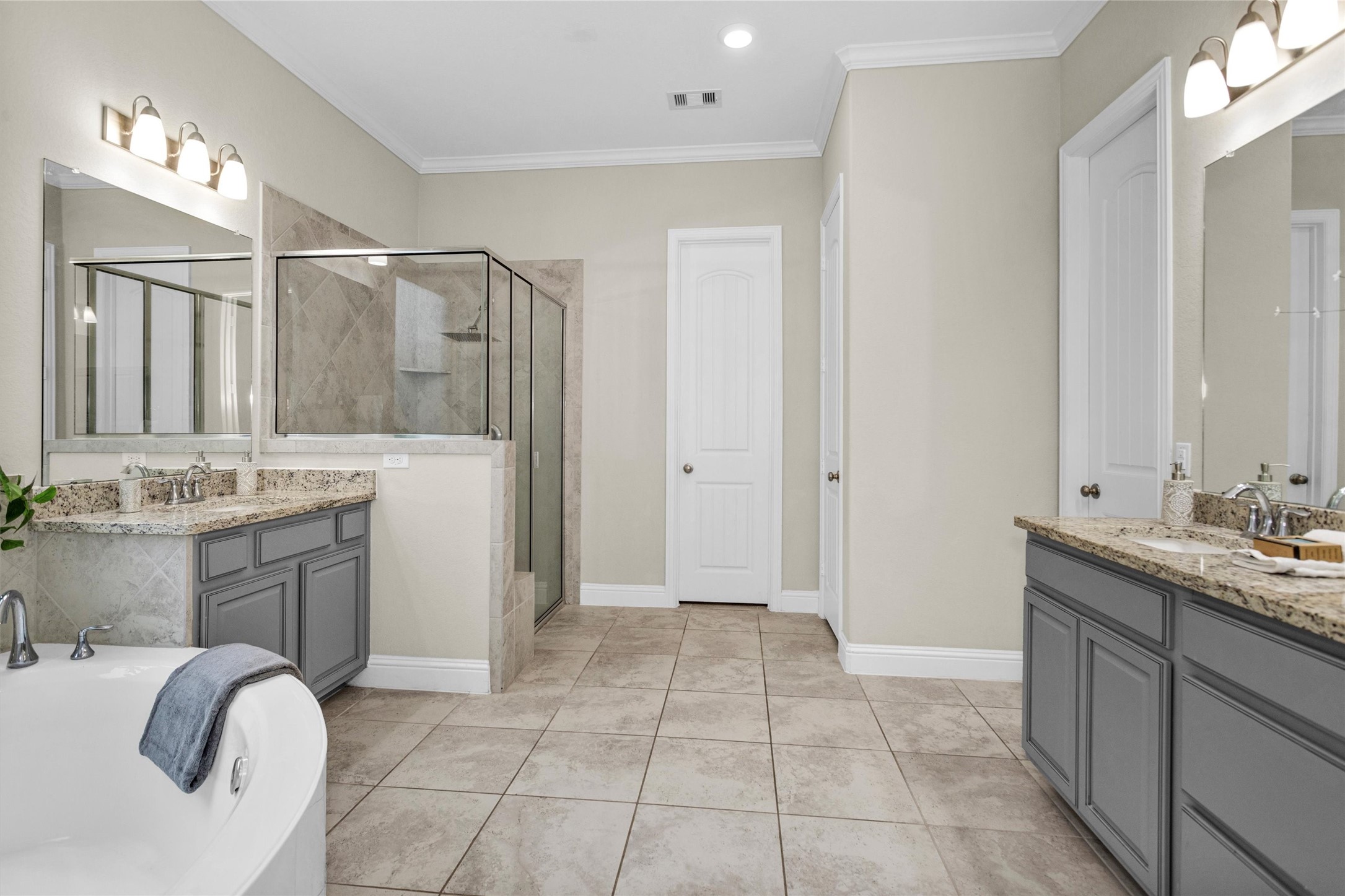 3622 Lister Drive Rosharon, TX 77583 - Photo 20 of 44 a bathroom with a granite countertop sink a mirror and a bathtub