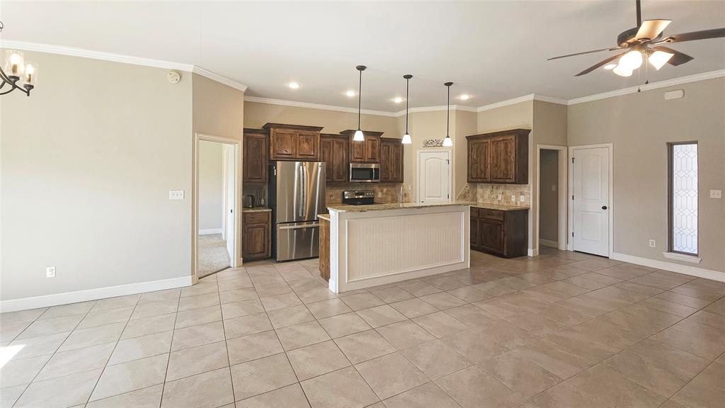 5765 Abbey Road Abilene, TX 79606 - Photo 4 of 11 a view of a kitchen with a refrigerator and a sink