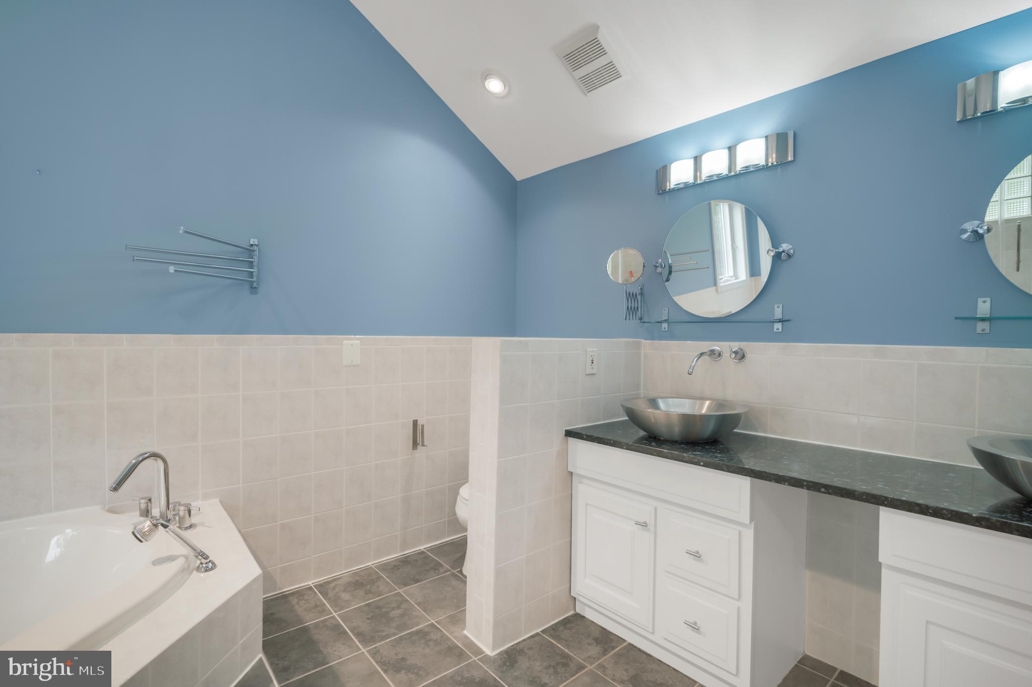 3111 North Thomas Street Arlington, VA 22207 - Photo 18 of 40 a bathroom with a sink and a mirror