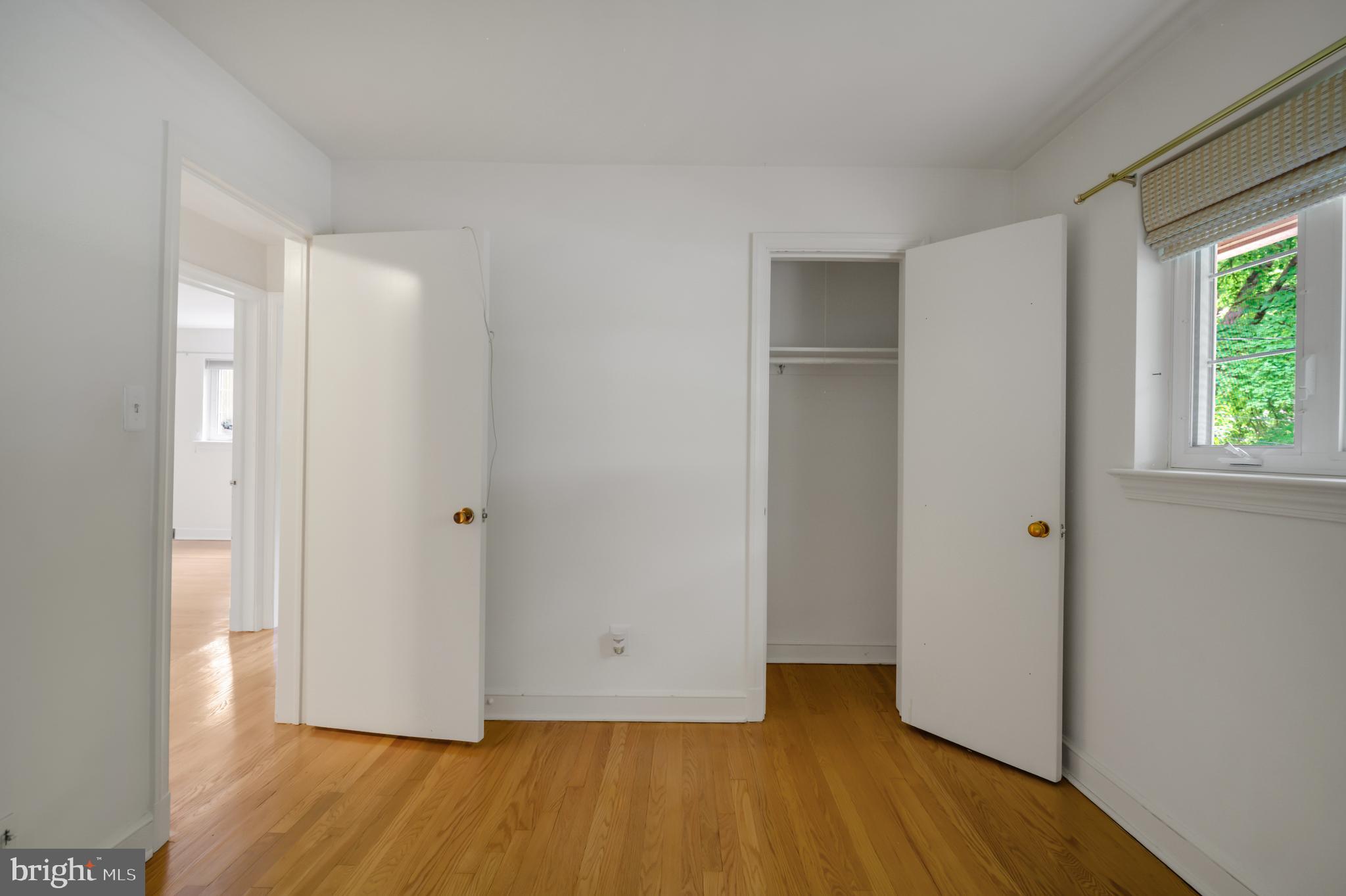 3111 North Thomas Street Arlington, VA 22207 - Photo 22 of 40 a view of an empty room with wooden floor and a window