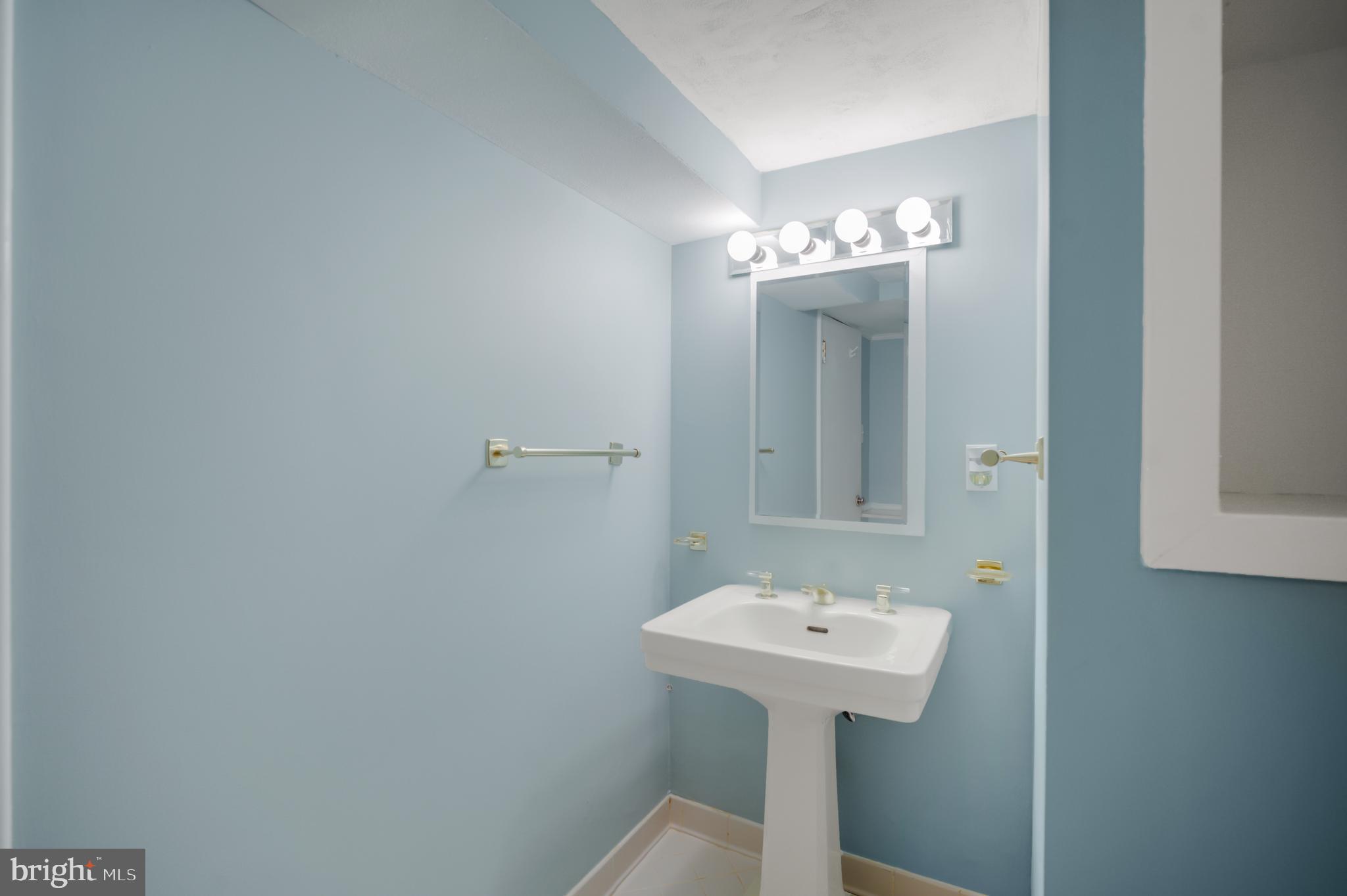 3111 North Thomas Street Arlington, VA 22207 - Photo 24 of 40 a bathroom with a sink a mirror and a toilet