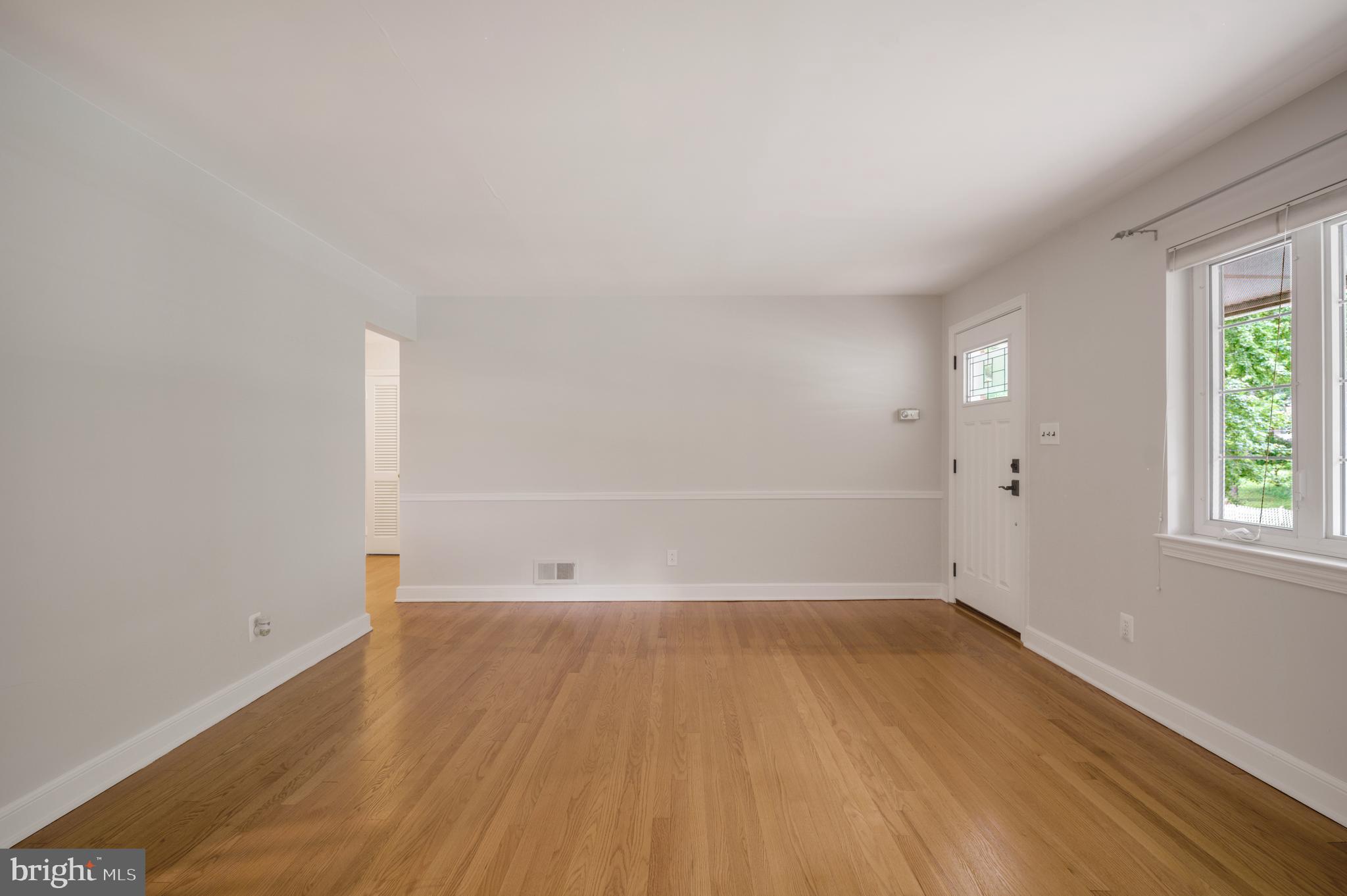 3111 North Thomas Street Arlington, VA 22207 - Photo 3 of 40 an empty room with wooden floor and windows