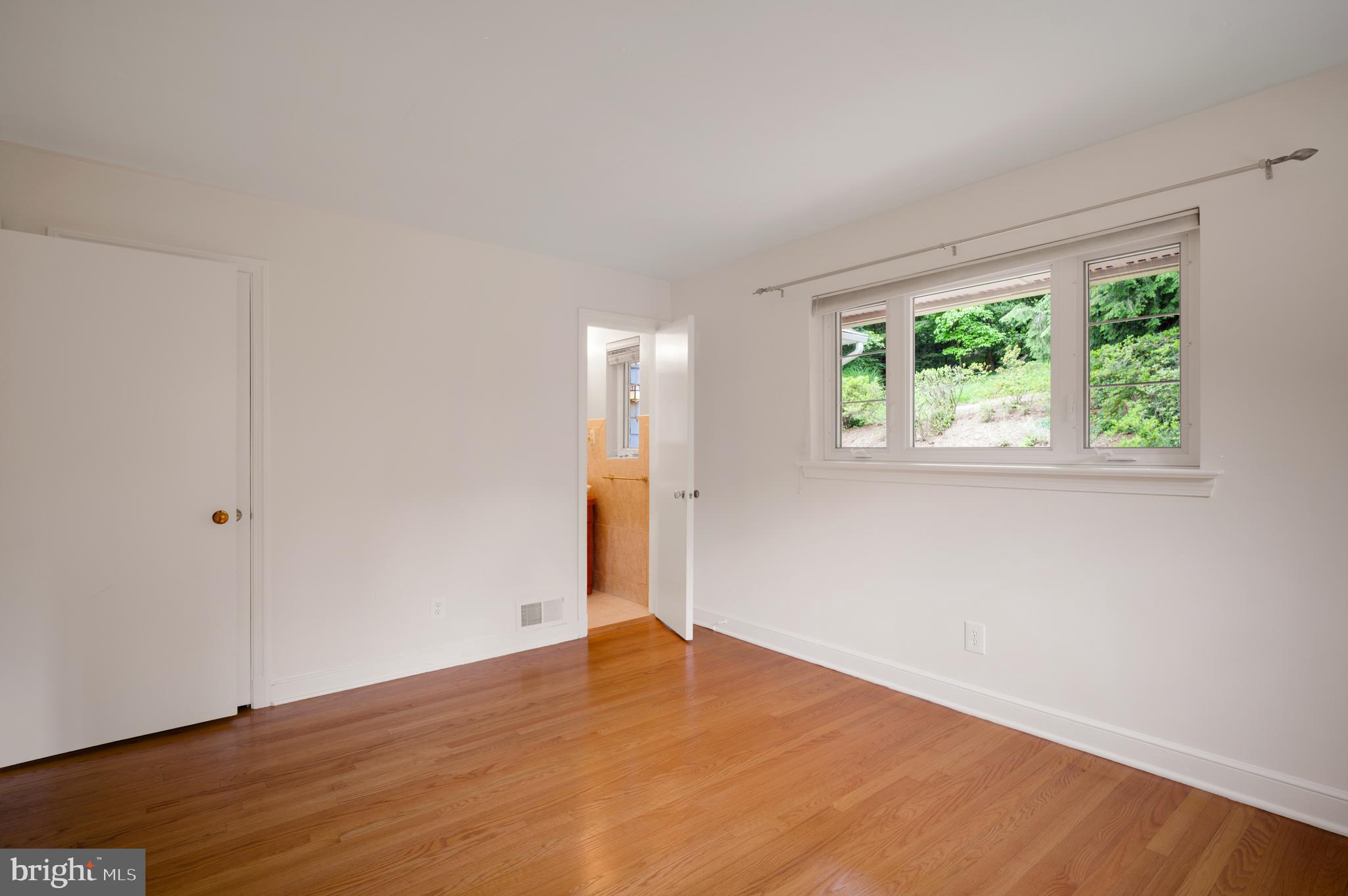 3111 North Thomas Street Arlington, VA 22207 - Photo 31 of 40 a view of an empty room with wooden floor and a window