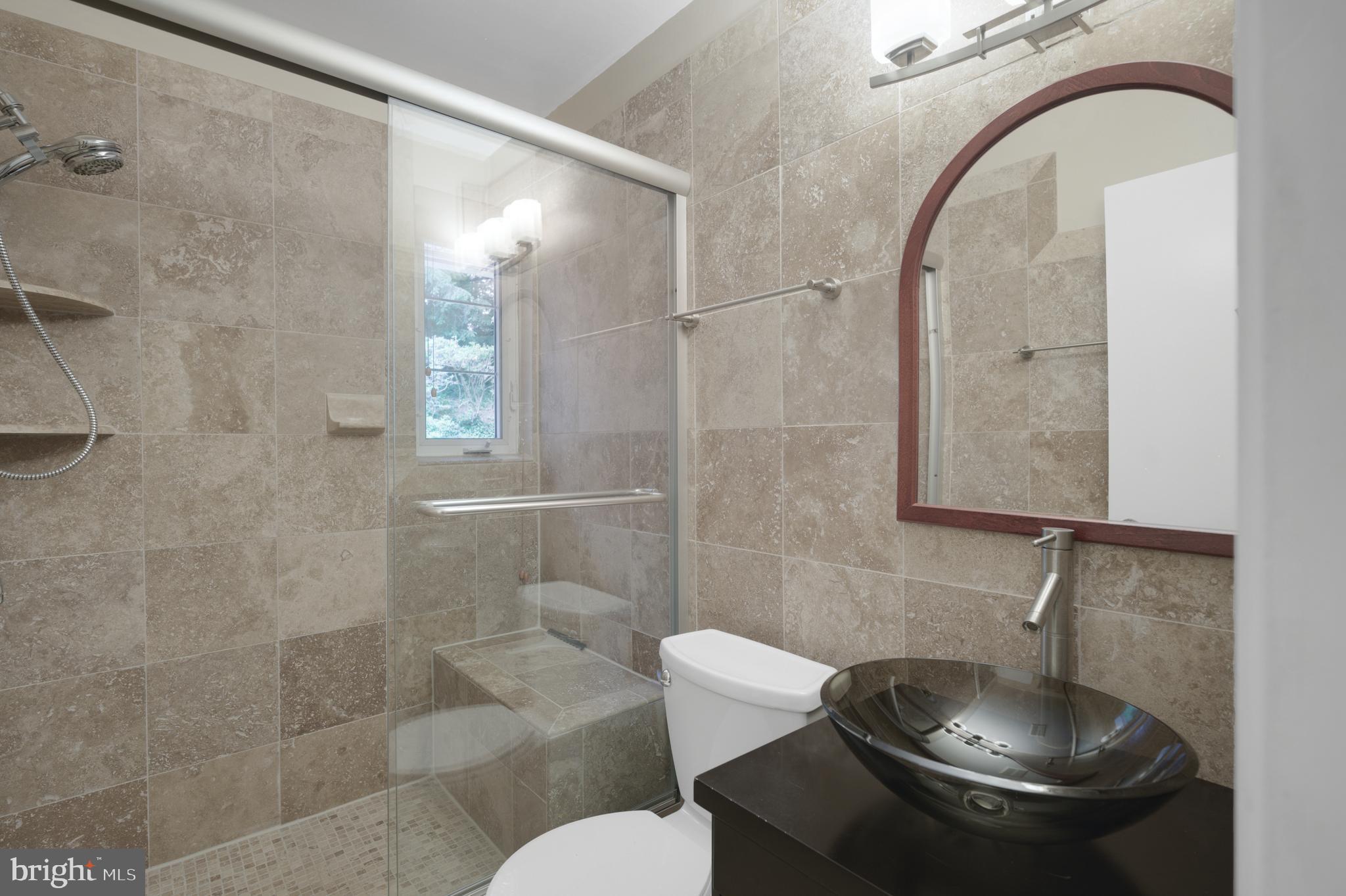 3111 North Thomas Street Arlington, VA 22207 - Photo 35 of 40 a bathroom with a sink toilet and shower